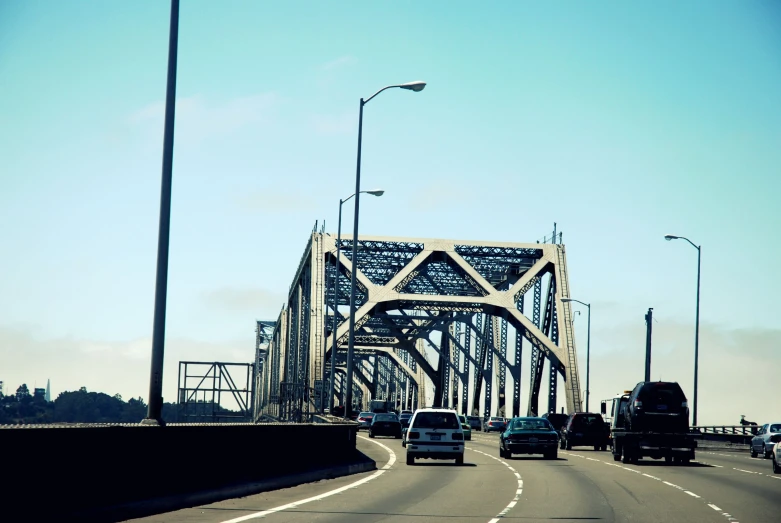 cars driving over a bridge in the middle of a road