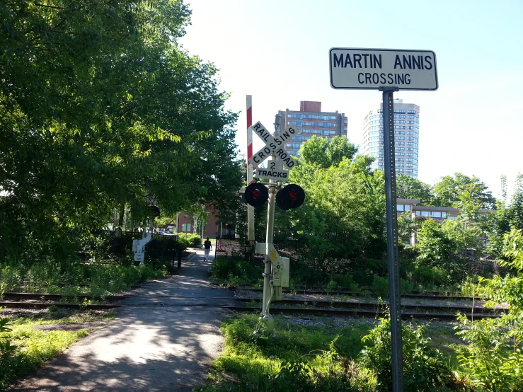 a couple of street signs on a pole next to a road