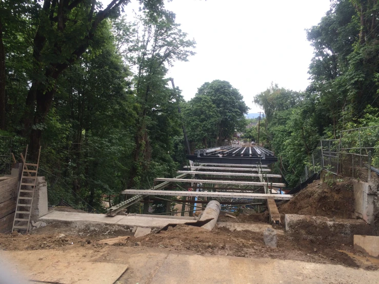 a wooden stairs is shown being built in the middle of some forest