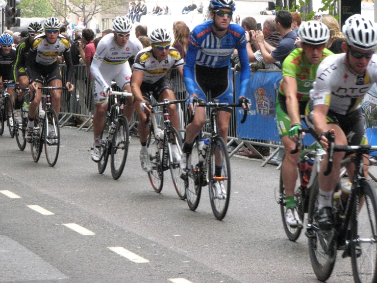 several people on bicycles riding in a race