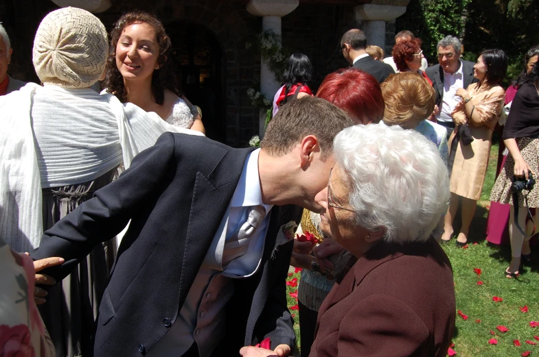 two people touching hands in front of many people