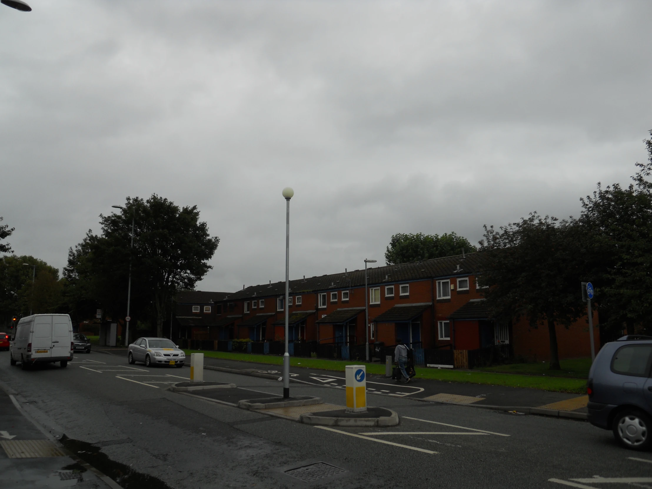 several cars parked on the road in front of a building