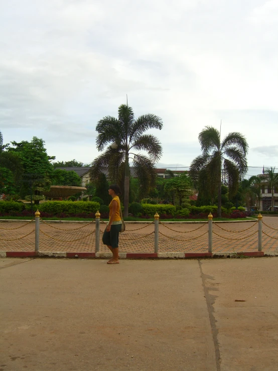 a man is standing on the side walk near the street