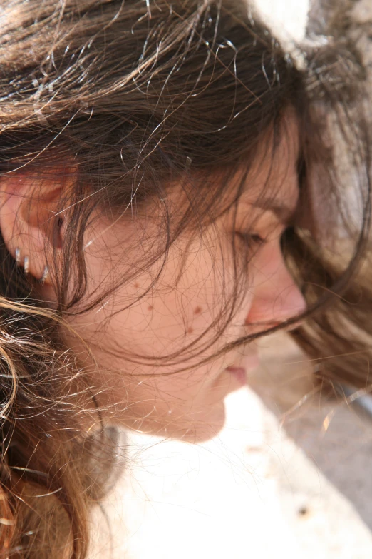 a girl with long hair is looking away