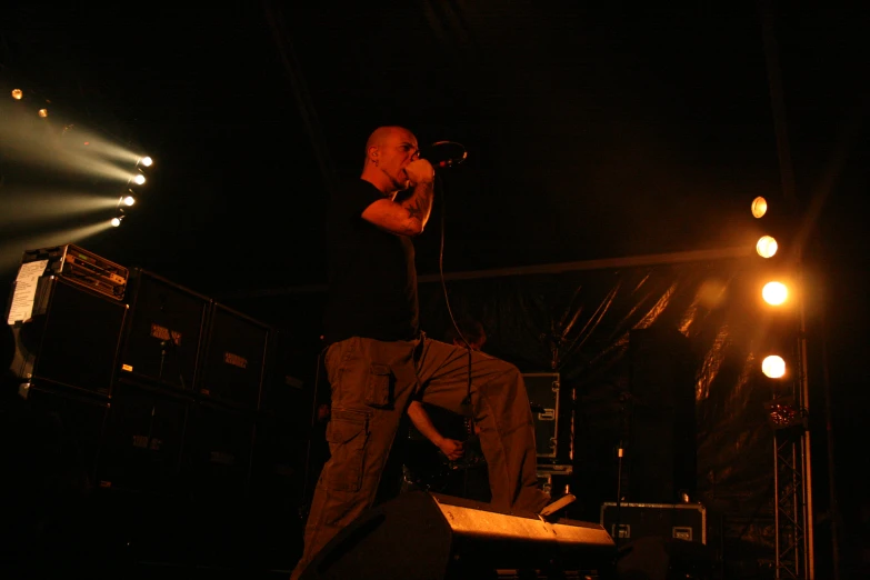 a man standing up on a stage with a microphone