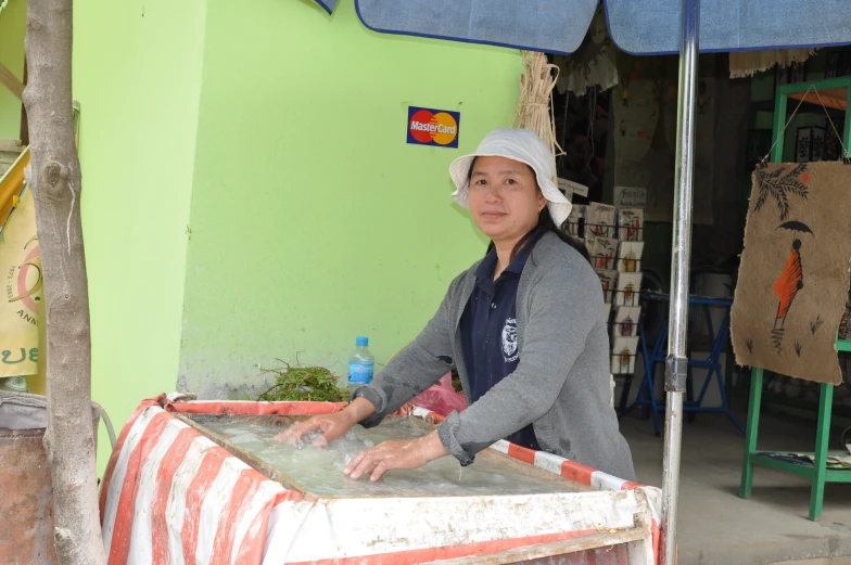 a woman that is standing behind a table