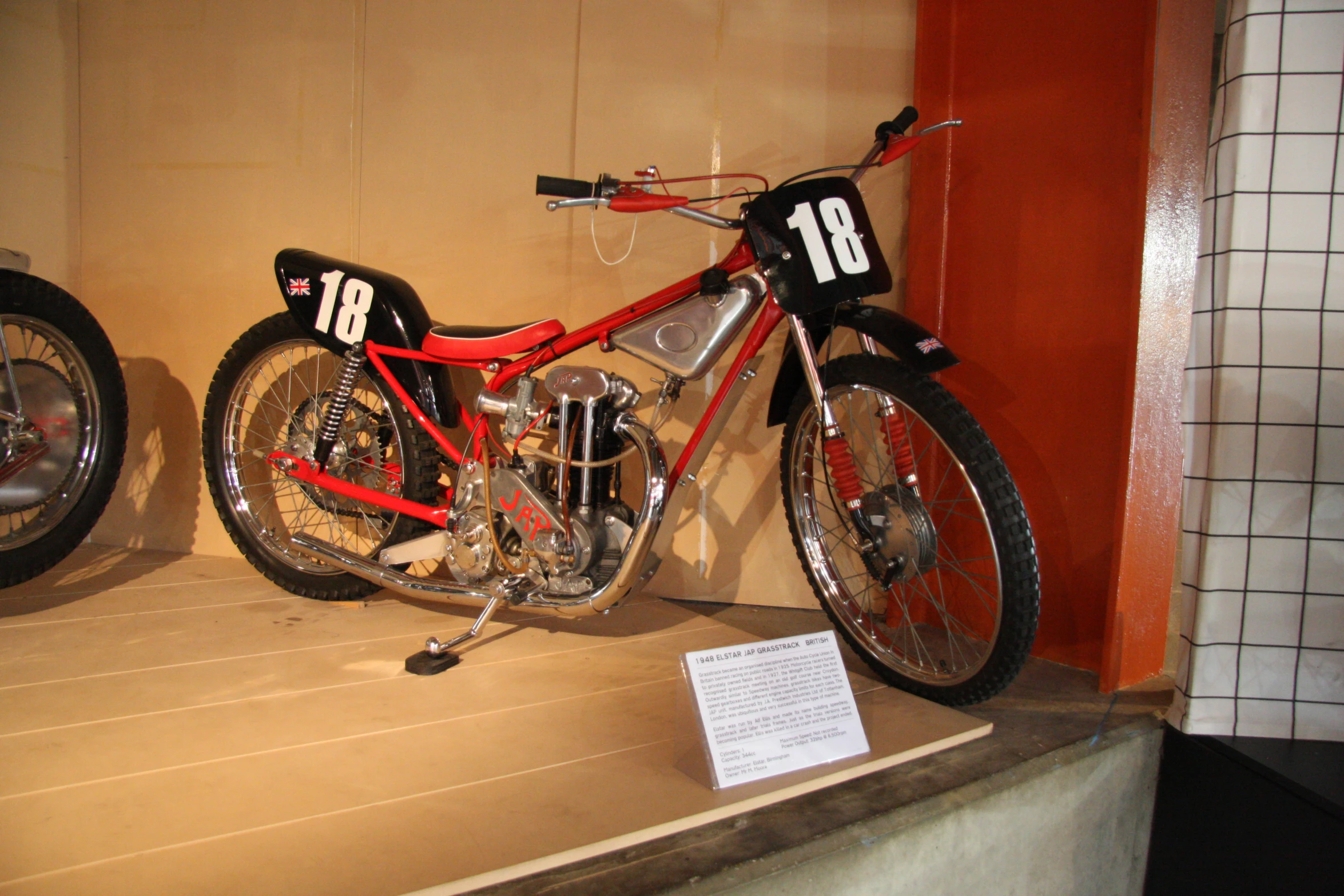 a motorcycle on display at a museum next to two other motorcycles