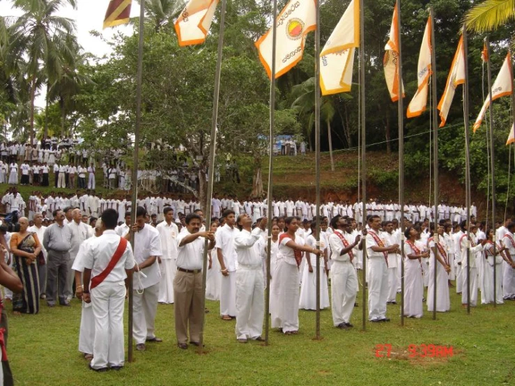 many flags that are being held by men in white uniforms