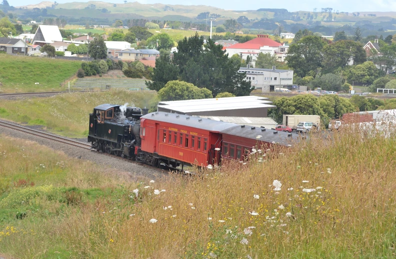 a train engine traveling down tracks near a rural town