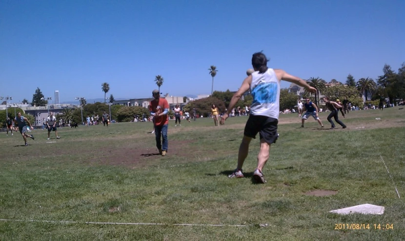 people playing on a grass field with the blue sky