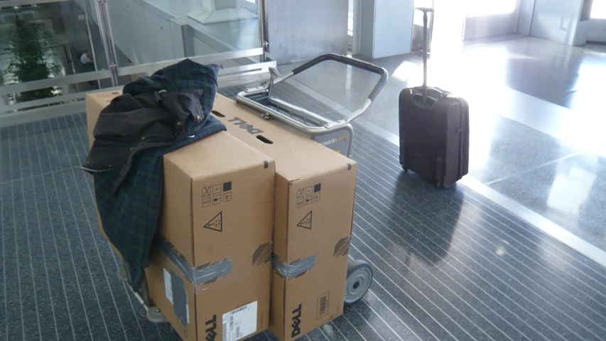 boxes with luggage next to a suitcase that is on the ground