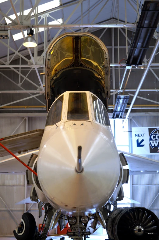 the inside of a hangar with an airplane parked under it