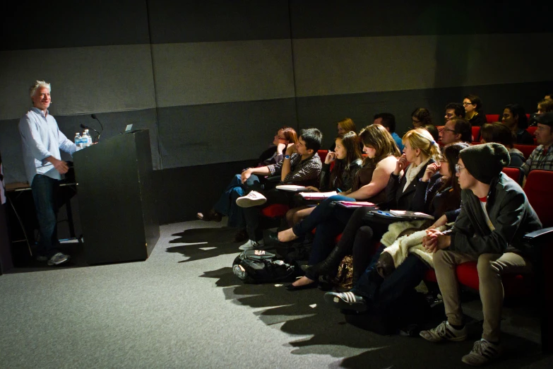 a man gives a lecture to a group of people