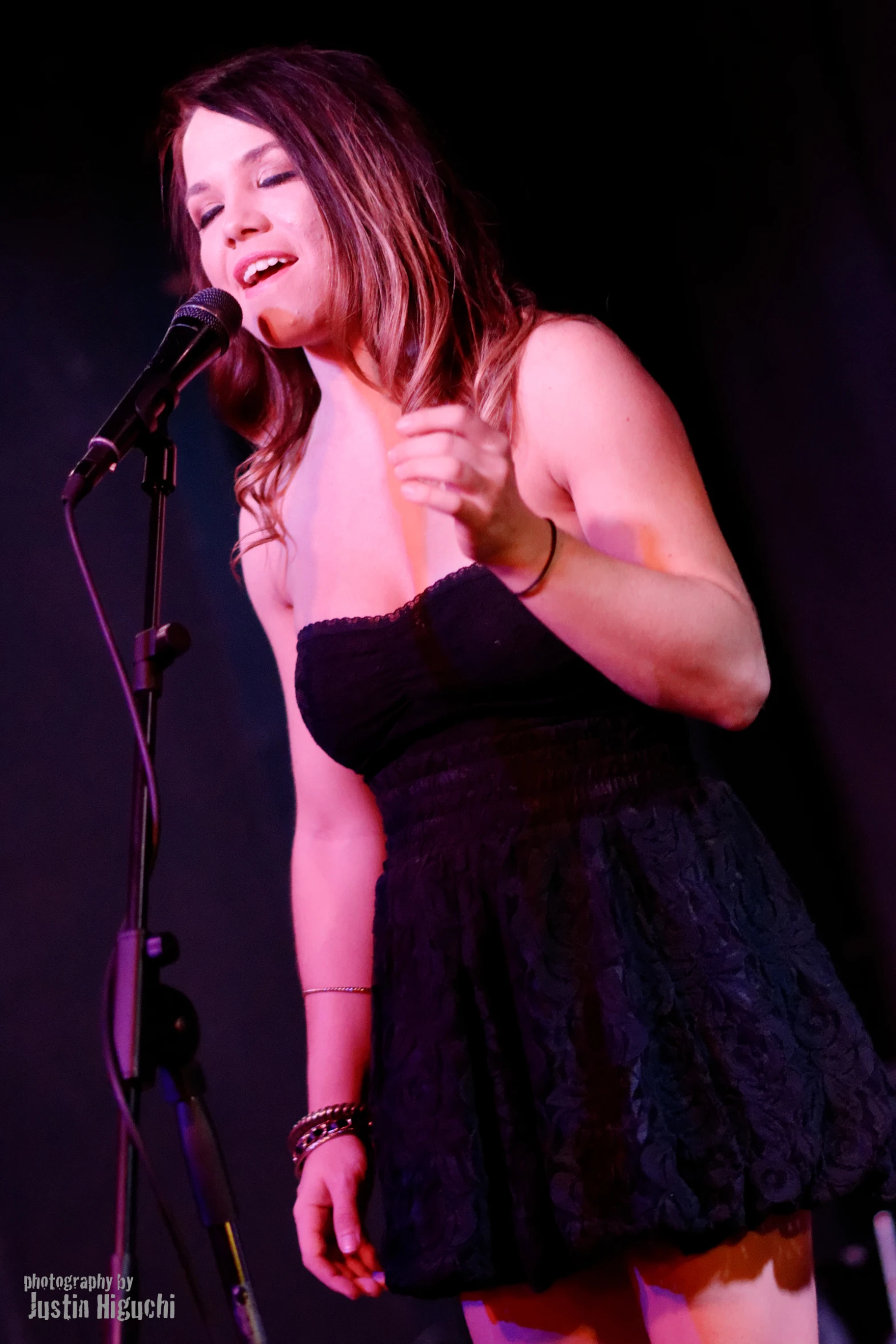 a woman on stage singing into a microphone