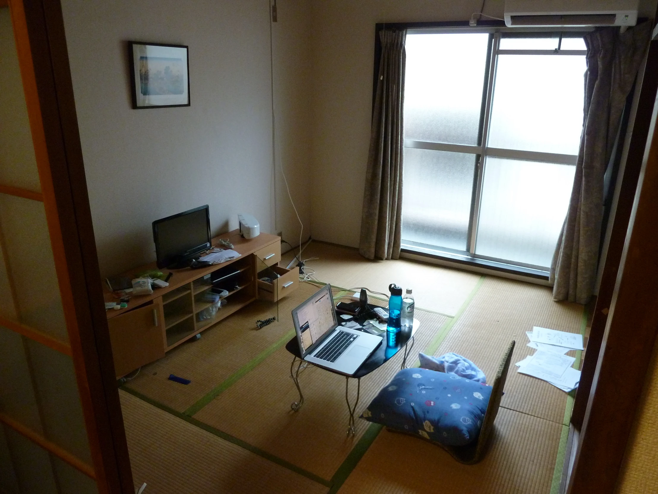 a room with a desk and laptop computer