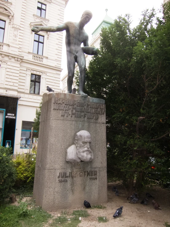 a large grey statue in front of a building