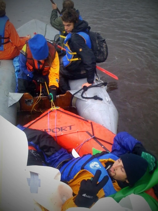 a group of people standing in a raft on the water