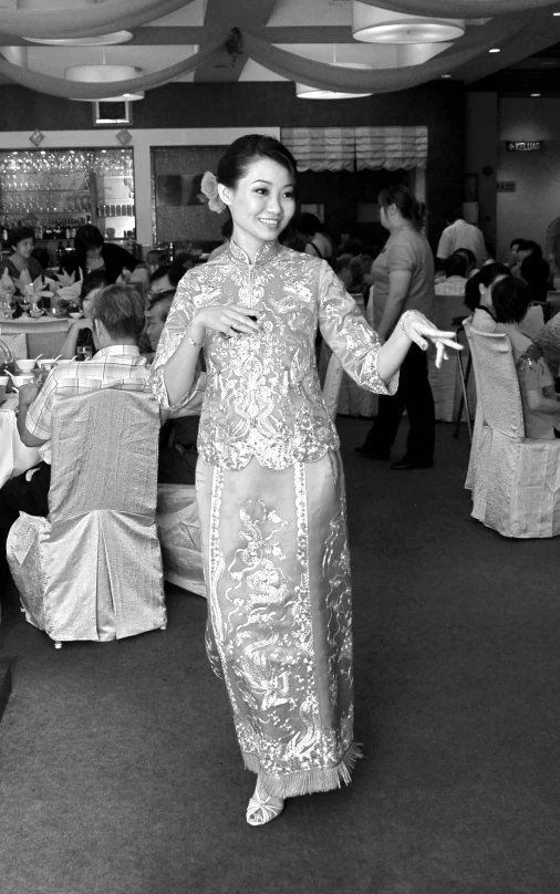 this po shows a woman standing in an elaborately decorated ballroom