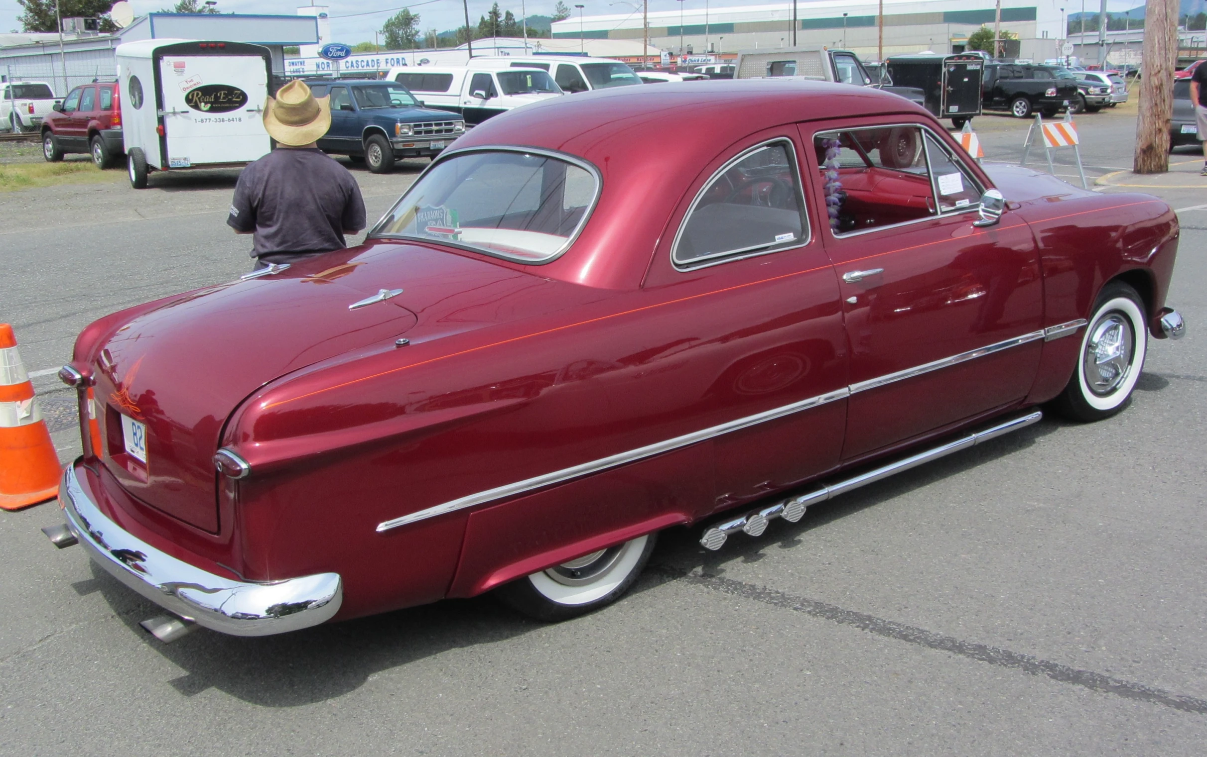 an old fashioned car sits in a parking lot