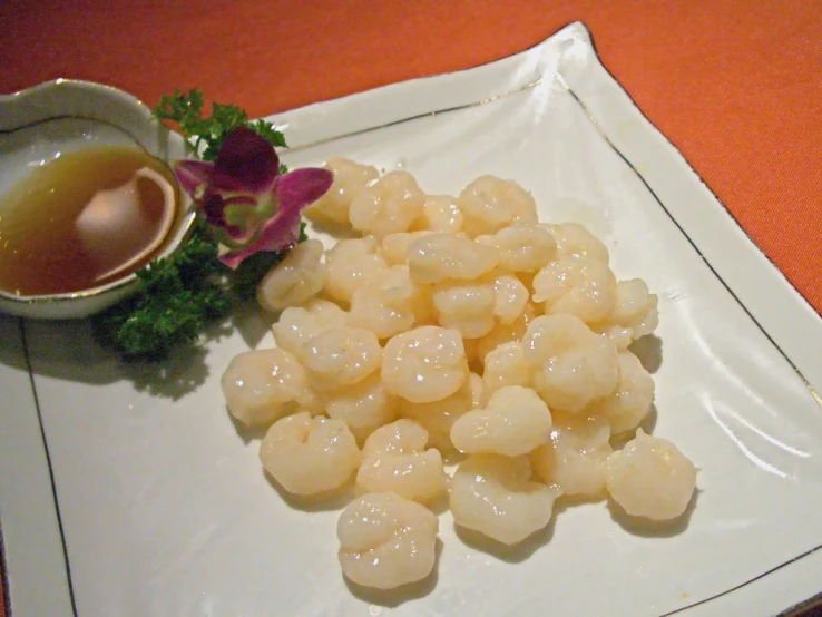 some food and drinks on a plate next to a saucer