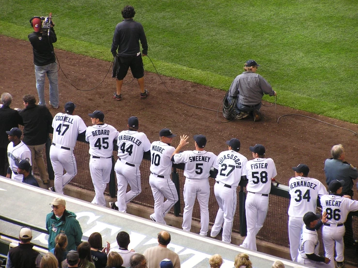 a crowd of baseball players congregates on the field