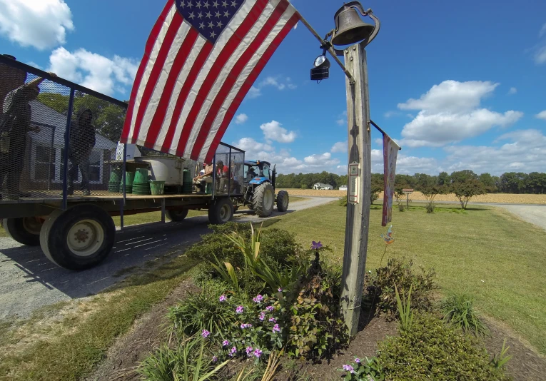 an american flag hung on the back of a truck