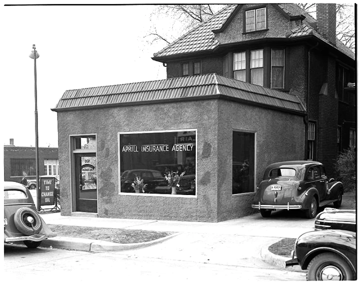 an old po of some cars parked outside