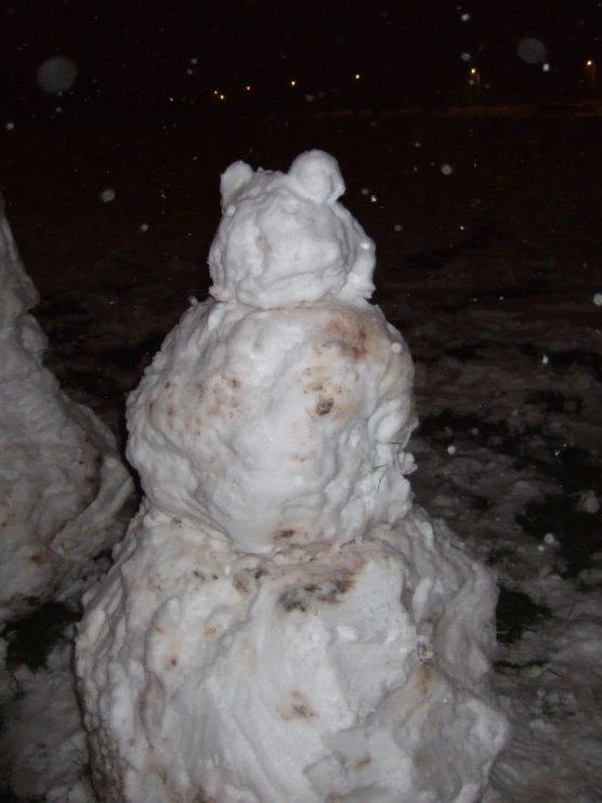 a snow man made of various sizes of snow