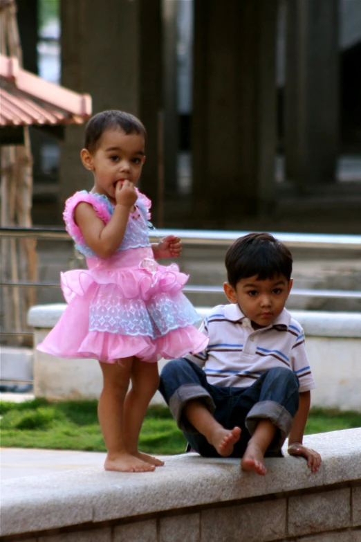 a boy and girl standing next to each other