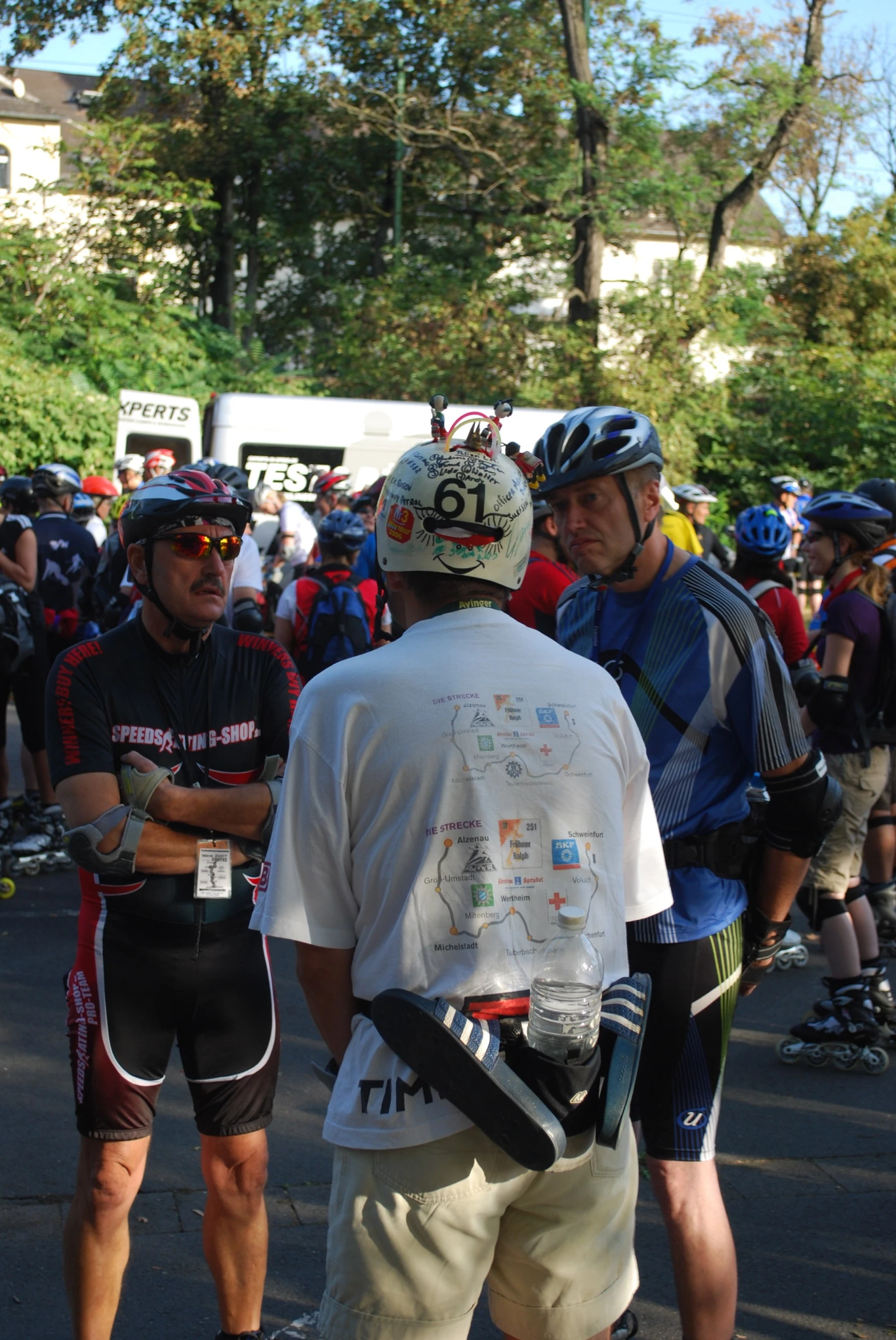 group of cyclists gathered together outside in helmets