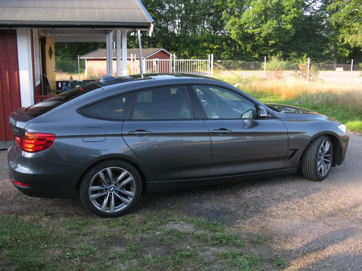 a gray car is parked in a driveway
