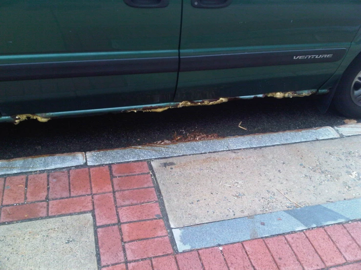 a blue van with a large black sticker parked in front of it