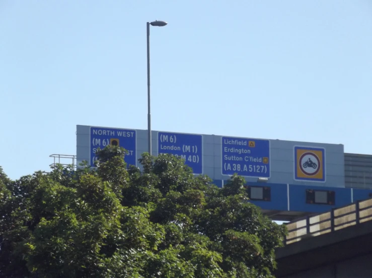 a number of signs in a foreign language above trees