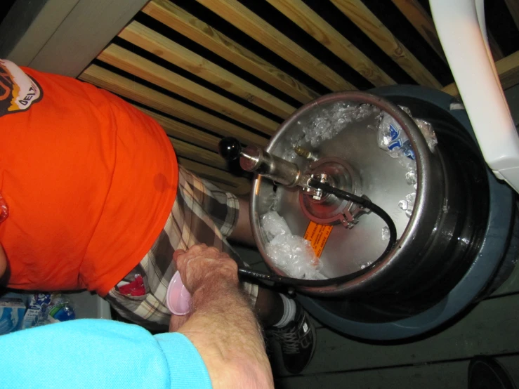 a man is operating a water machine in a kitchen