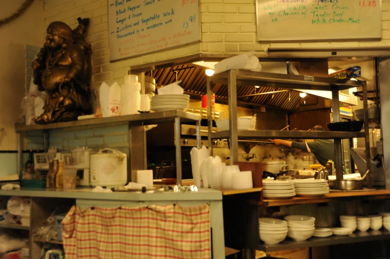 a kitchen with a lot of dishes on the shelves