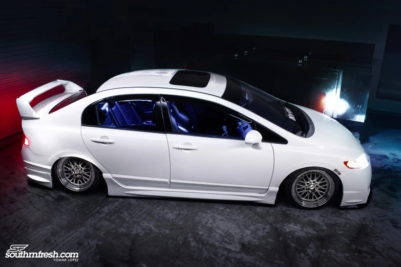 white honda civic gt in an arena with a red light