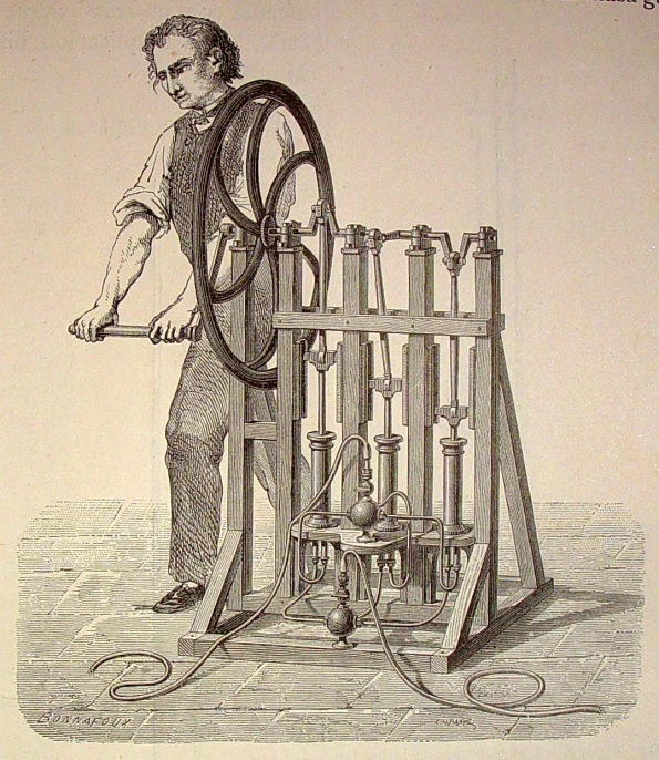 a man working with a spinning wheel while leaning against the back of his cart