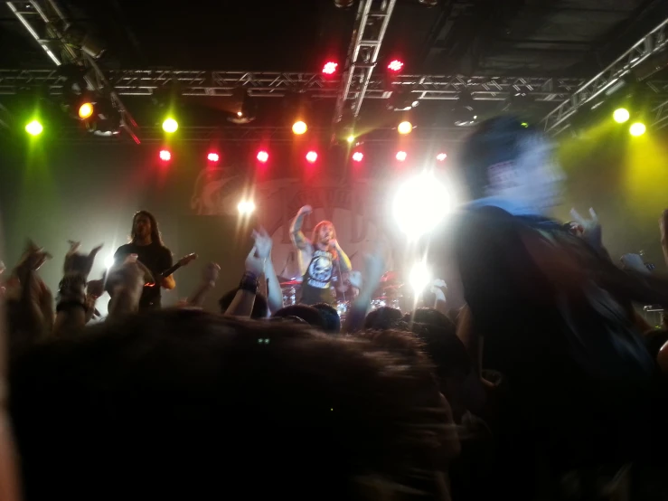 people in an auditorium on stage with their legs up