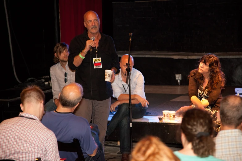 a group of people sitting in front of a crowd