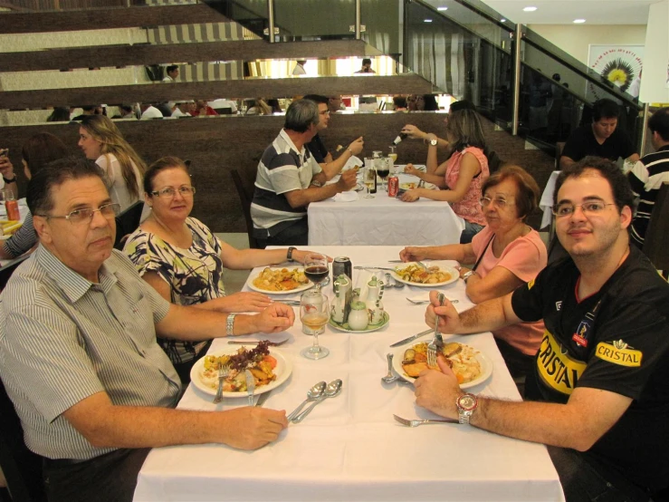 the people are eating food at the table together