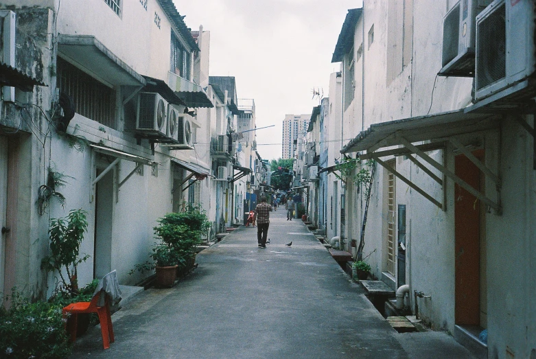 an alley way in the rain with a person riding on one of the lanes