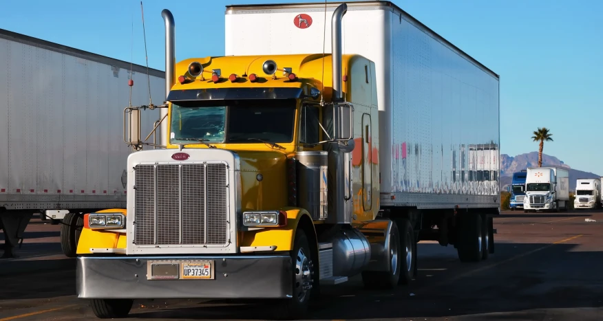 a truck is driving down the highway as others wait