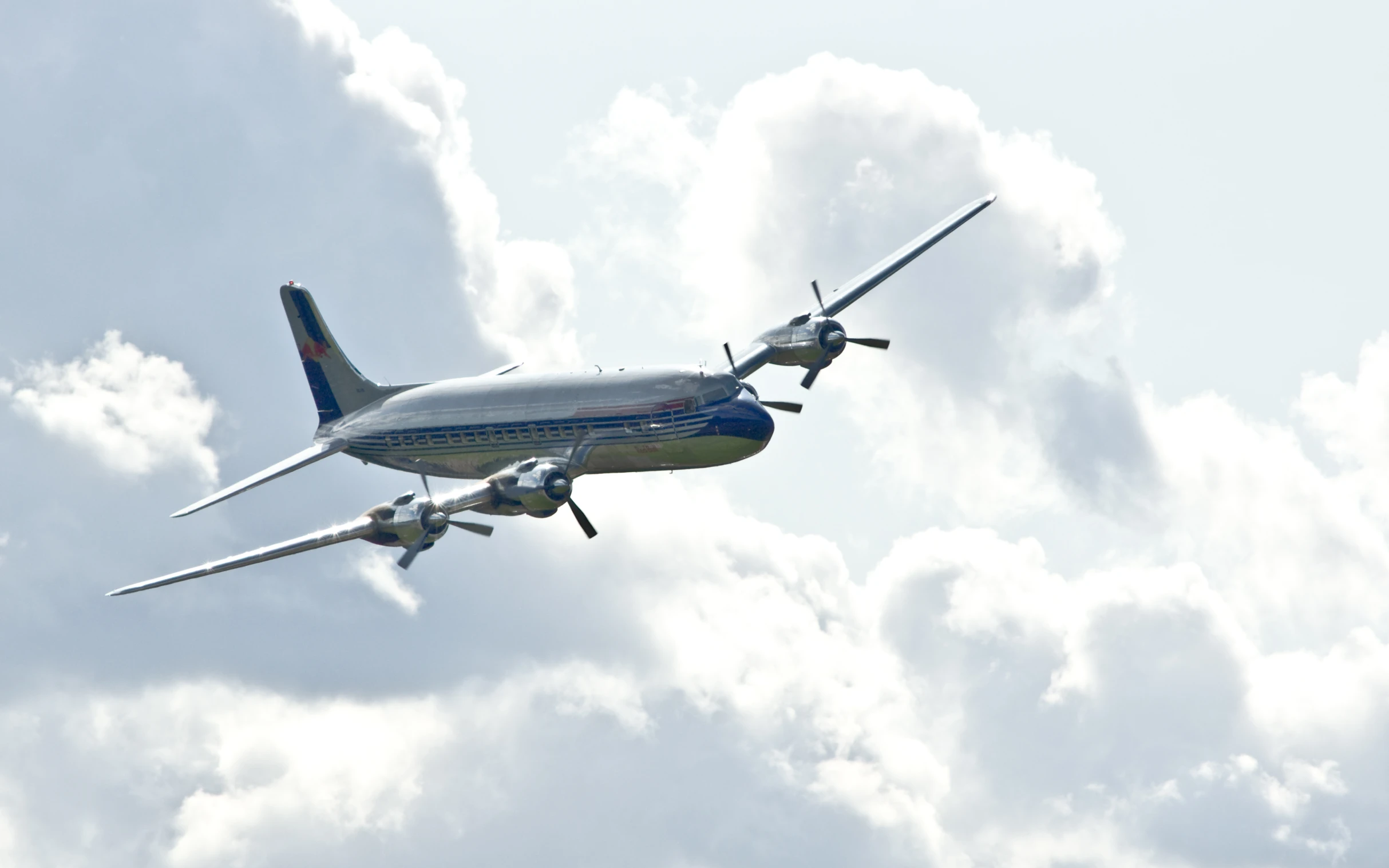 two airplanes flying in front of white clouds