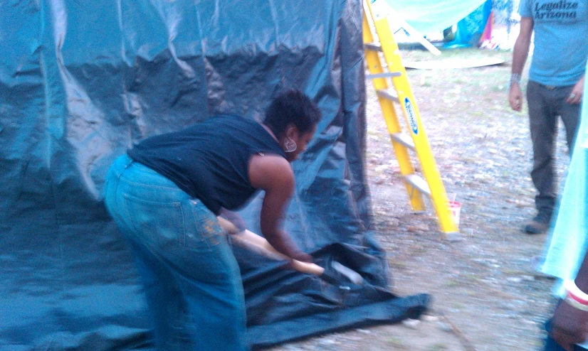 a person is taking apart a cloth covered structure