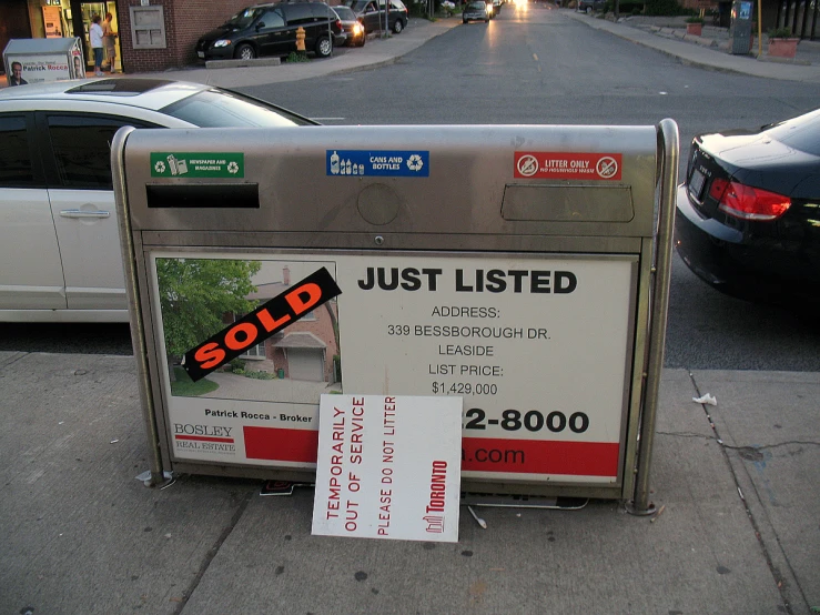 the mail box with some stickers has been knocked over