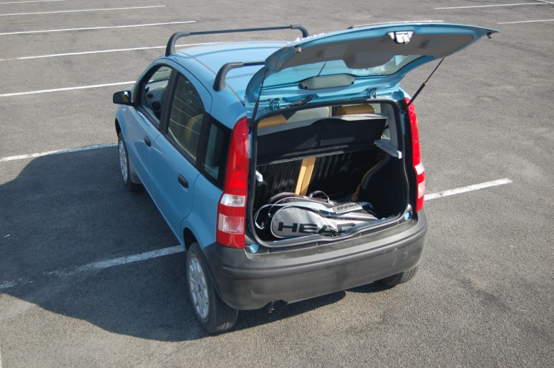 the back end of a small compact car with its trunk open