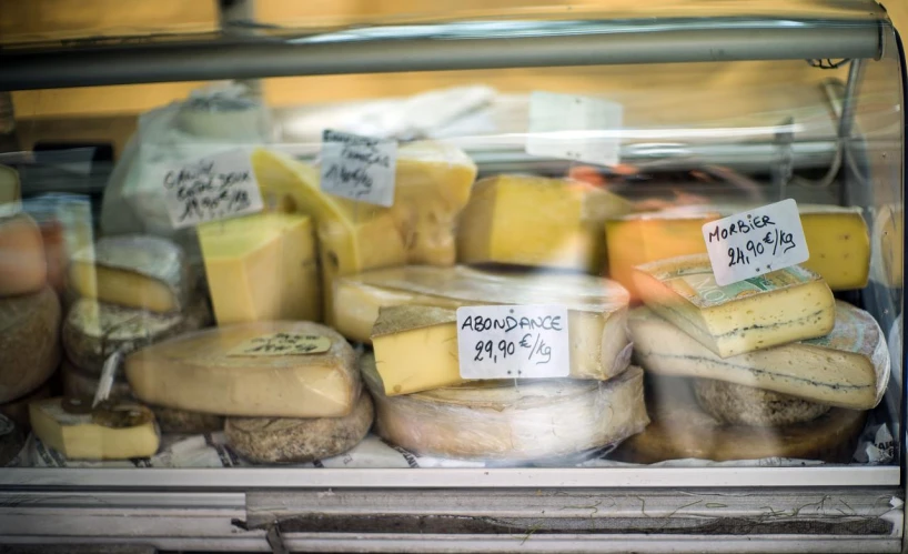 various types of cheeses in a store case