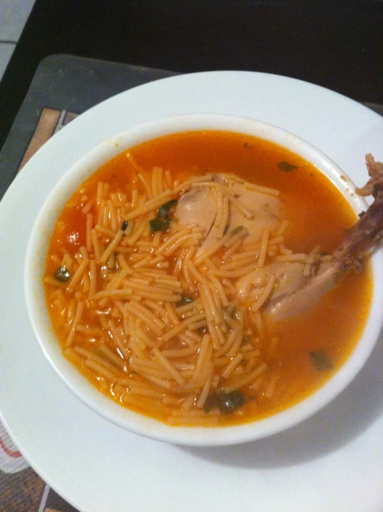 a white bowl filled with a pasta soup