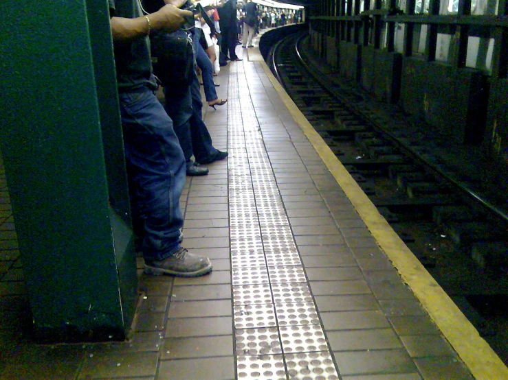 people waiting for the next train at a station