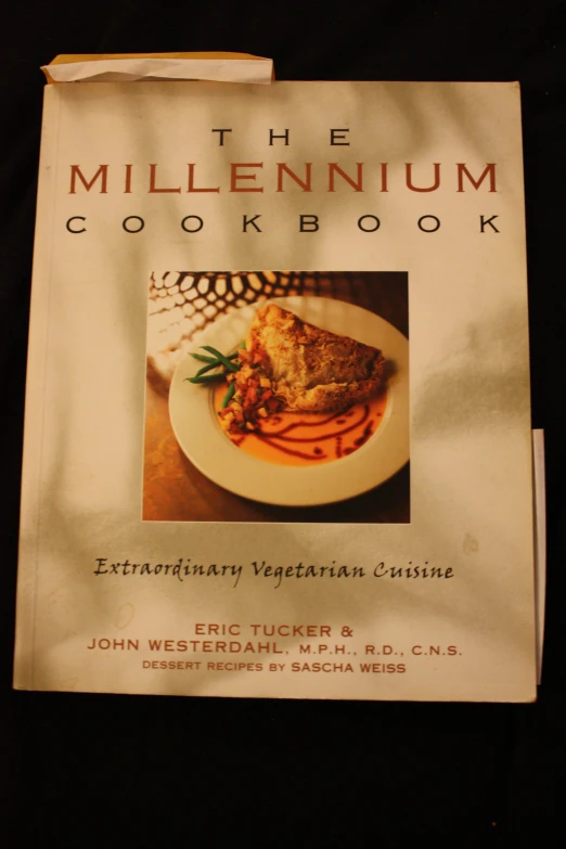 the millennium cook book sits on a white plate